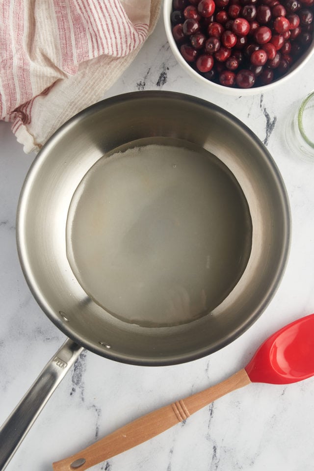 overhead view of water and sugar in a saucepan