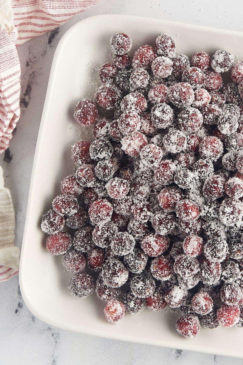 overhead view of sugared cranberries on a white tray