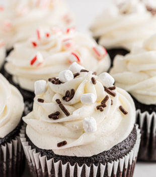 hot chocolate cupcakes on a white cake stand