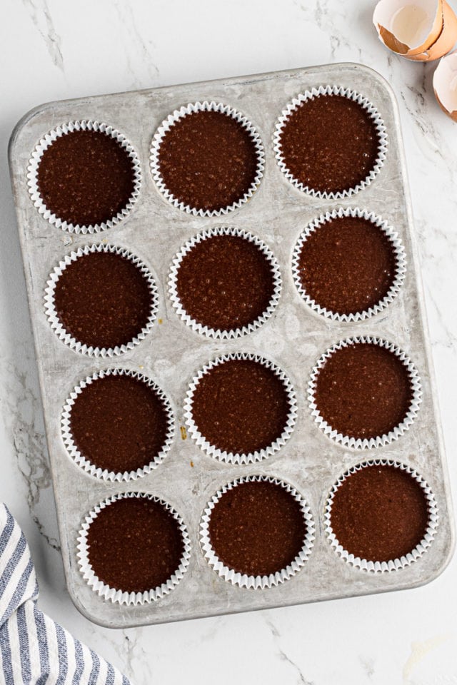 overhead view of chocolate cupcake batter in a muffin pan