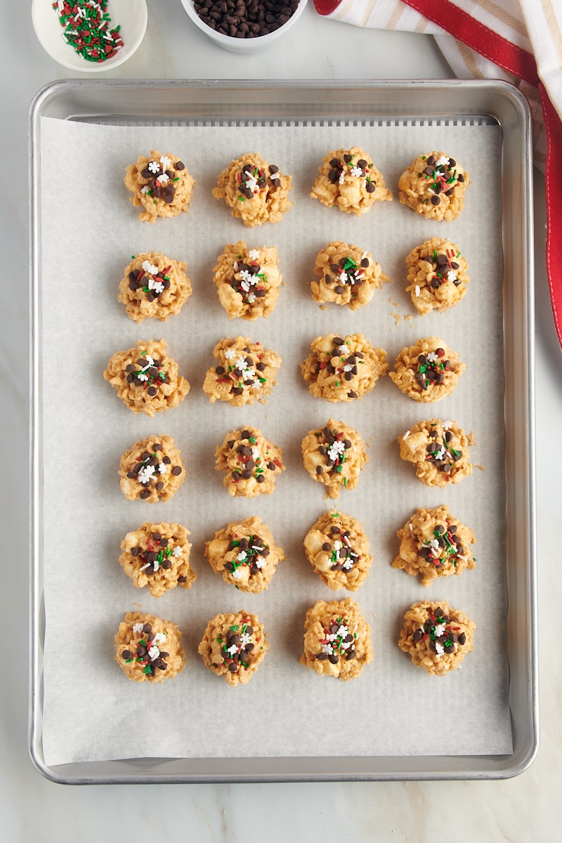 overhead view of avalanche cookies on a parchment-lined baking sheet