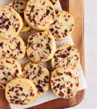 Overhead view of cranberry orange shortbread cookies on cutting board