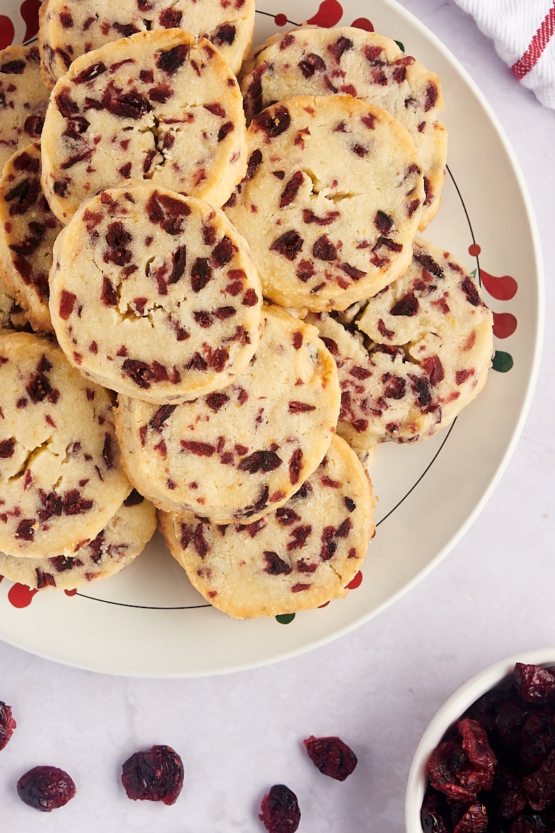 Plate with stack of cranberry orange shortbread cookies