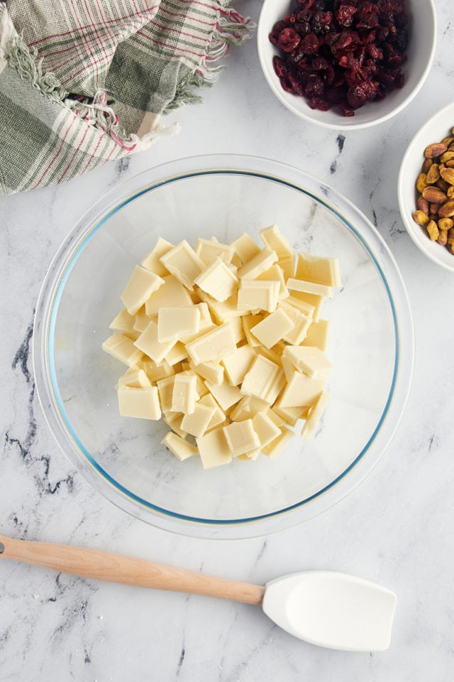 overhead view of chopped white chocolate in a glass bowl