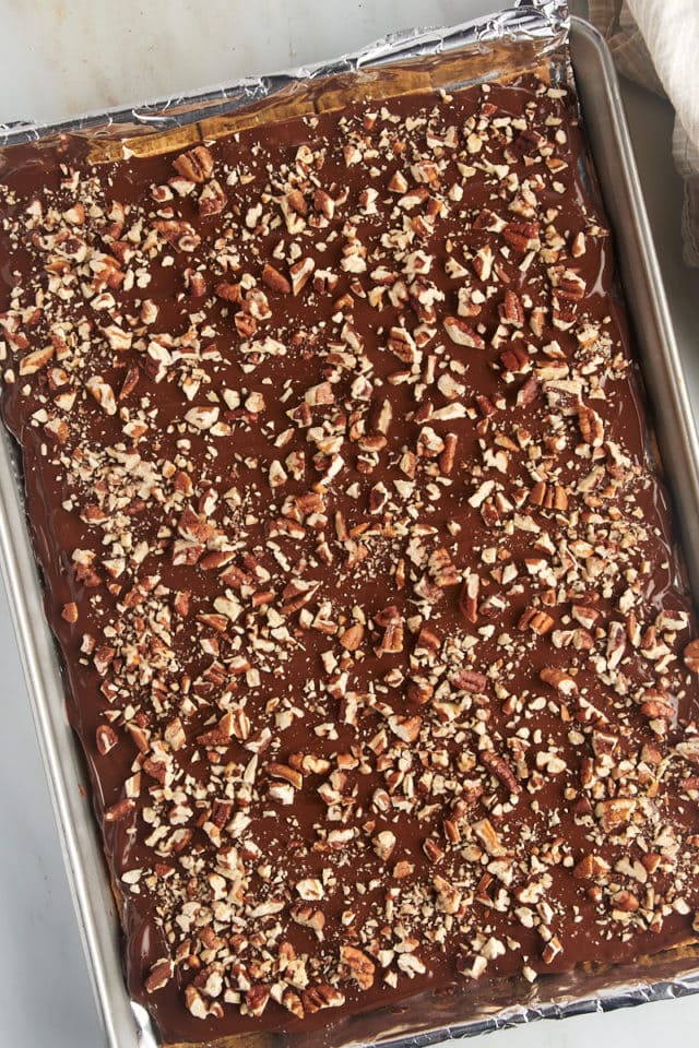 overhead view of graham cracker toffee topped with chopped toasted pecans