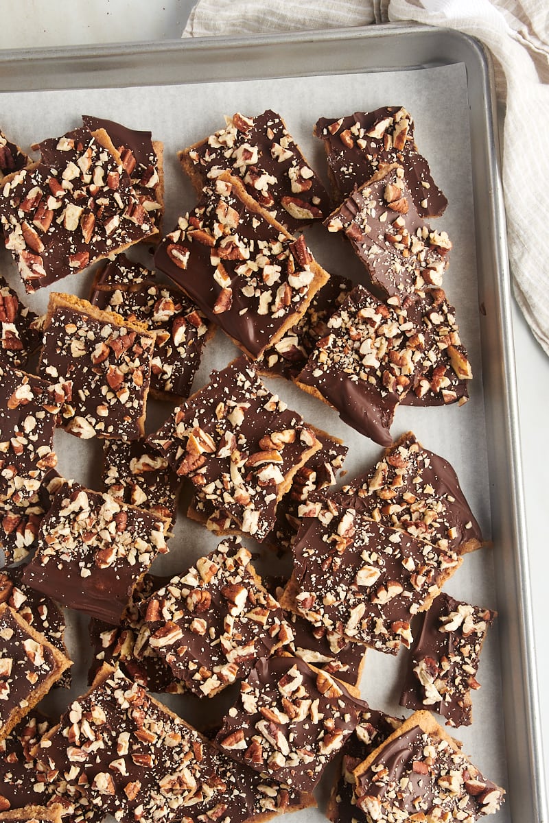 overhead view of pieces of graham cracker toffee on a parchment-lined baking sheet