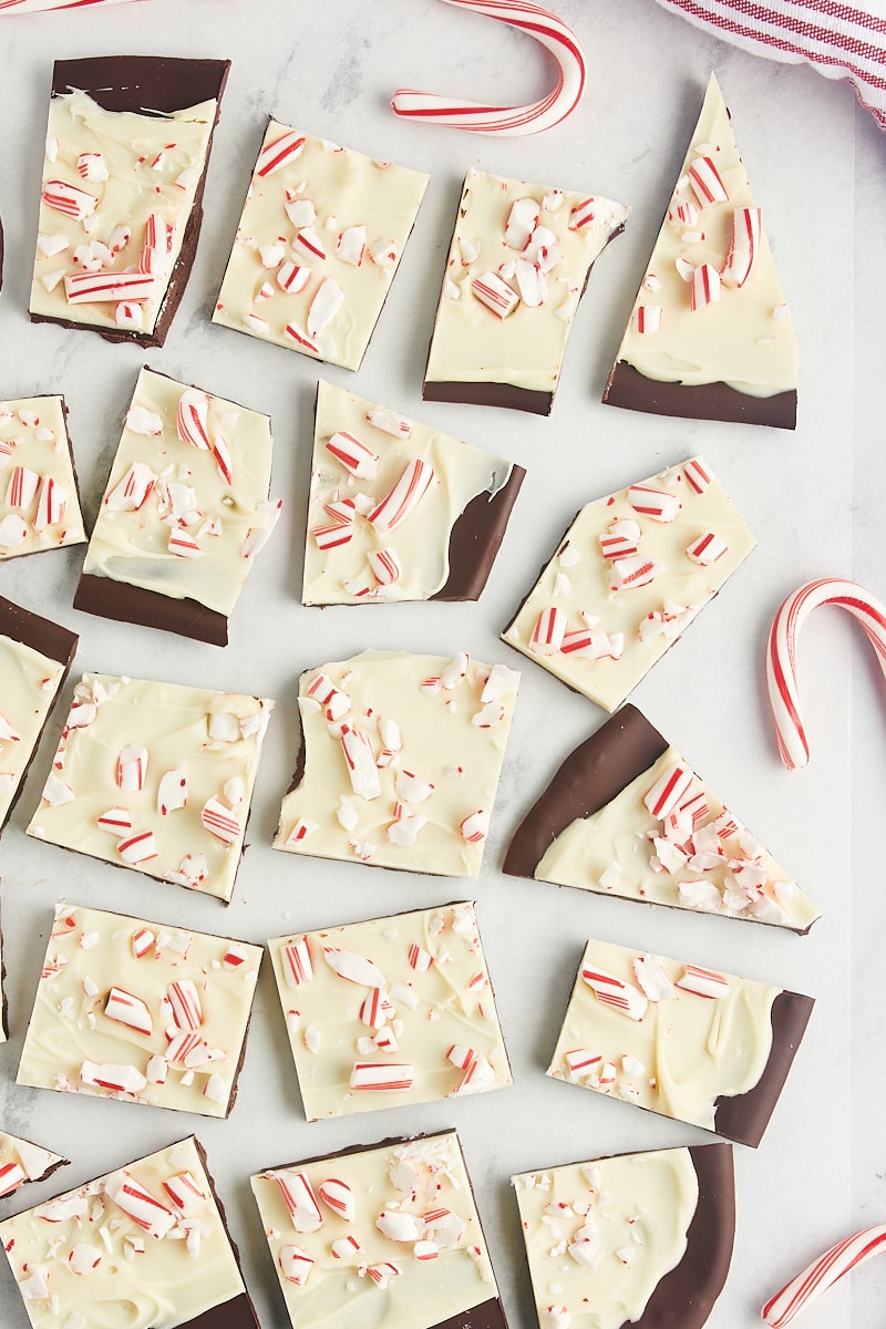 overhead view of several pieces of peppermint bark on a marble surface