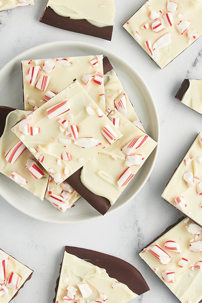 overhead view of peppermint bark piled on a white plate with more bark surrounding