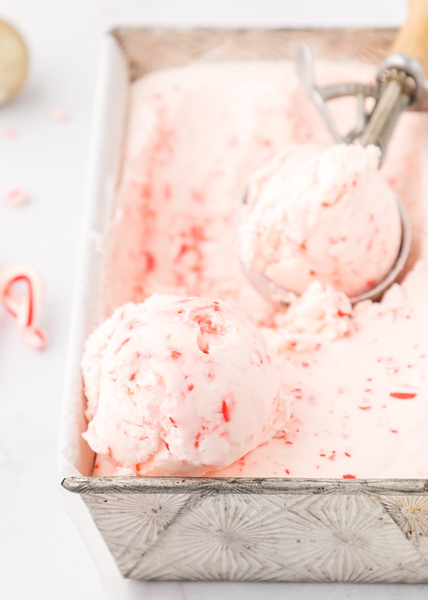 scoops of peppermint ice cream on top of more ice cream in a metal loaf pan
