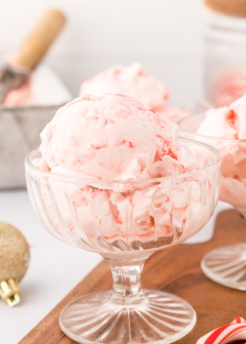 a footed glass dessert bowl filled with peppermint ice cream
