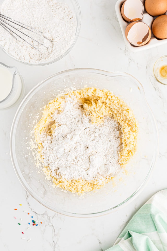 overhead view of dry ingredients added to cake batter