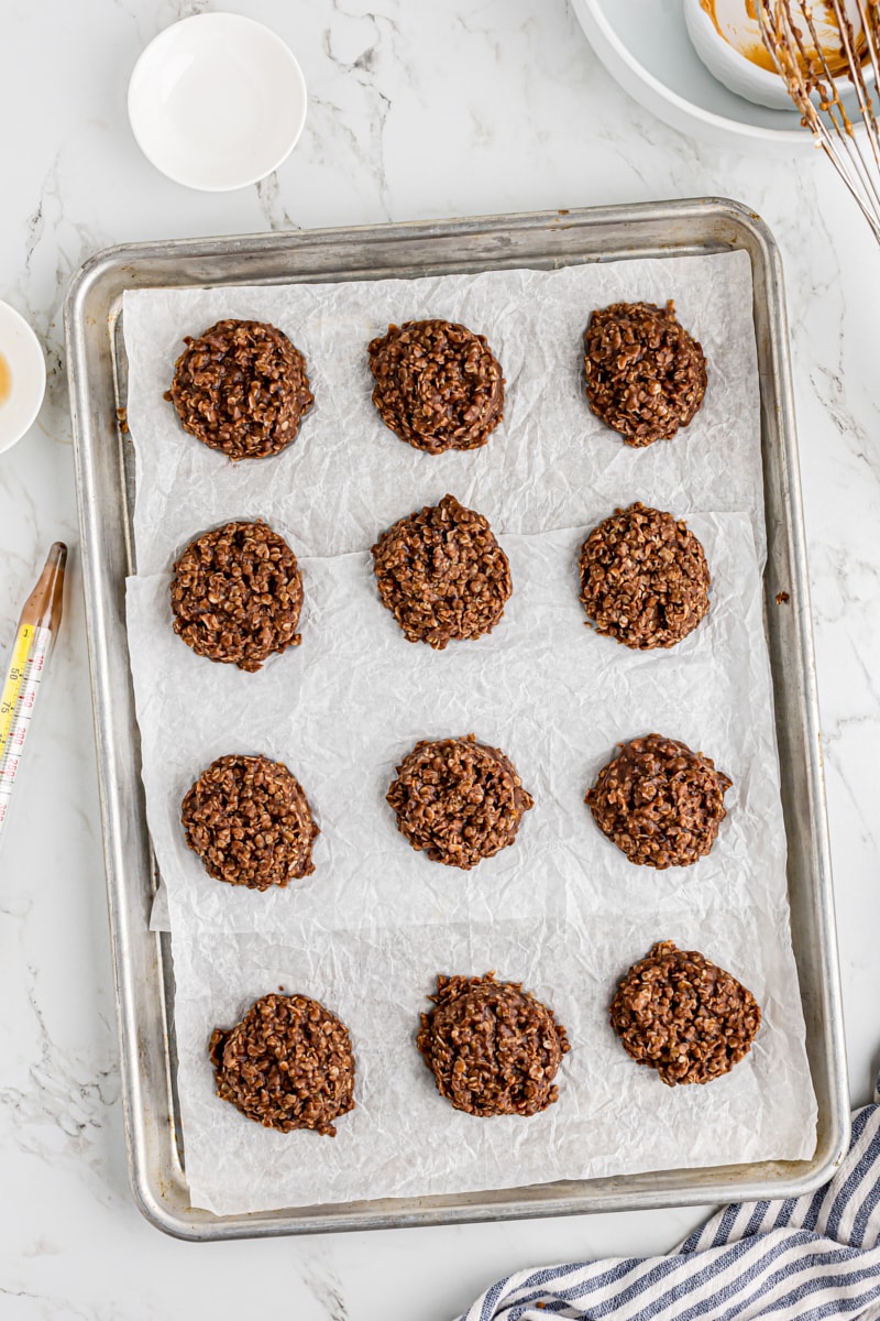 Overhead view of no-bake chocolate oatmeal cookies on sheet pan