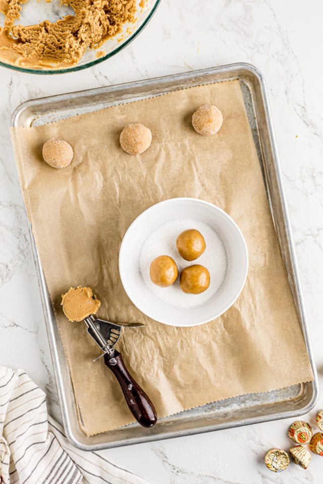 Rolling peanut butter dough balls in sugar