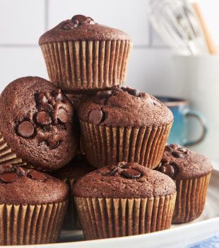 Stack of chocolate chocolate chip muffins on cake stand