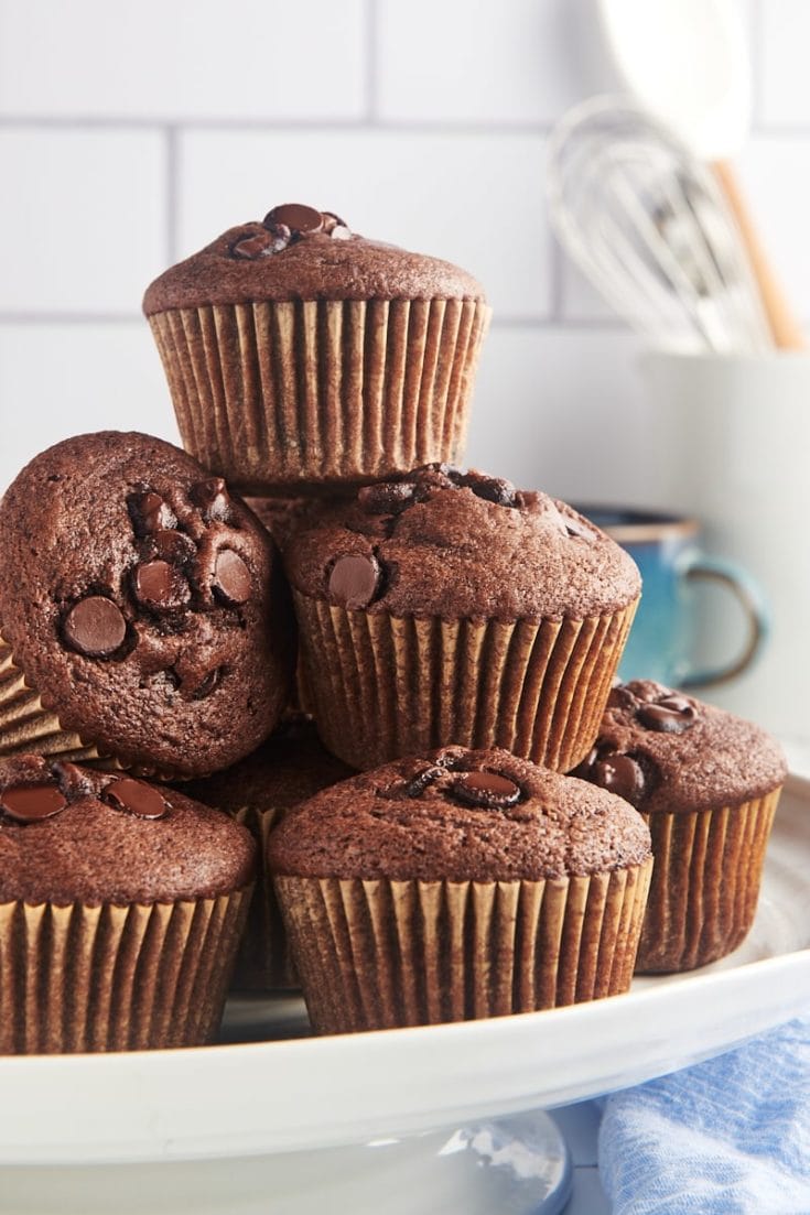 Stack of chocolate chocolate chip muffins on cake stand