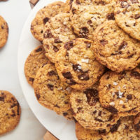 Plate piled high with crispy chocolate chip cookies