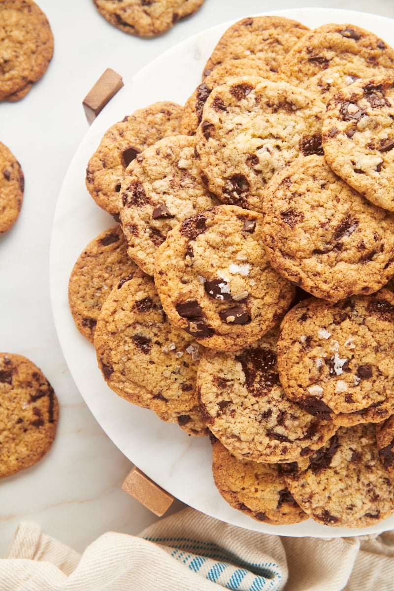 Plate piled high with crispy chocolate chip cookies