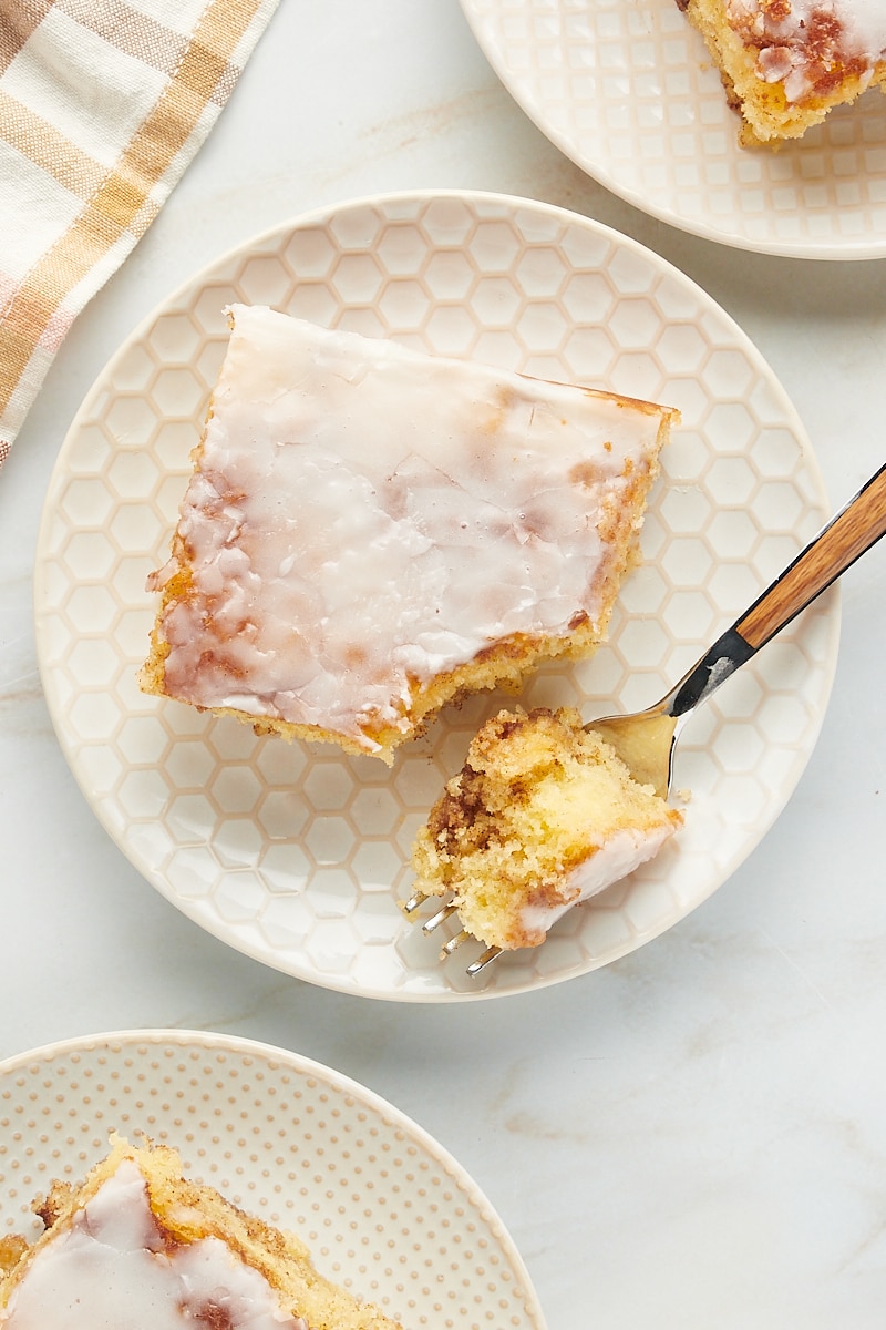 Slice of honey bun cake on plate with fork