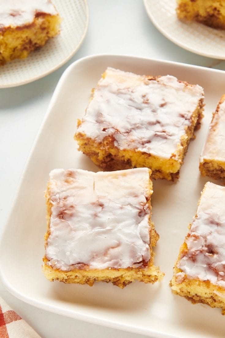 Squares of honey bun cake on platter