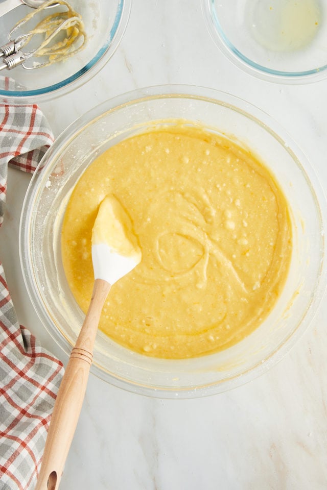 overhead view of mixed orange pound cake batter in a glass mixing bowl