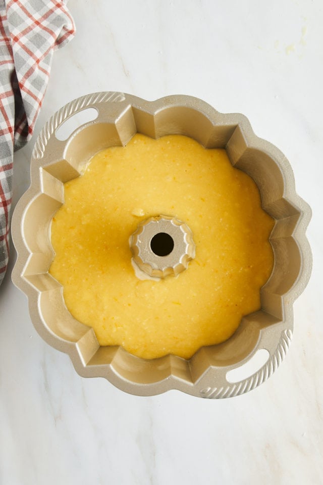 overhead view of orange pound cake batter in a Bundt pan