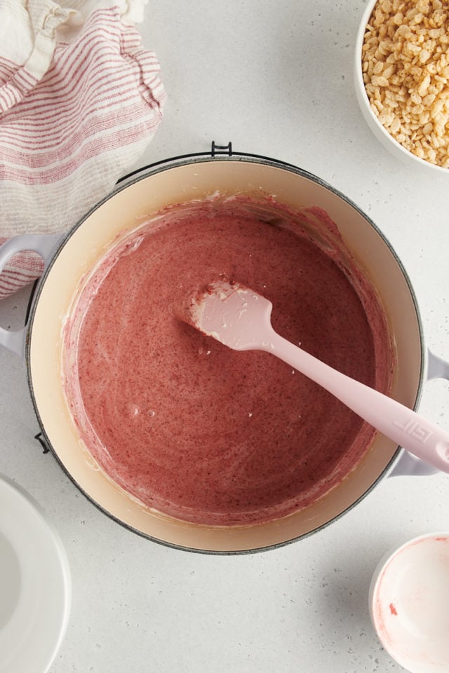 overhead view of melted marshmallows mixed with freeze-dried strawberry powder in a large pot