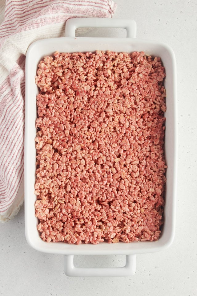 overhead view of strawberry rice crispy treats pressed into a 9x13 pan