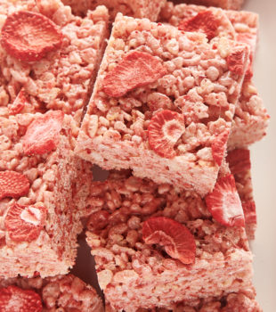 strawberry rice crispy treats piled on a white tray