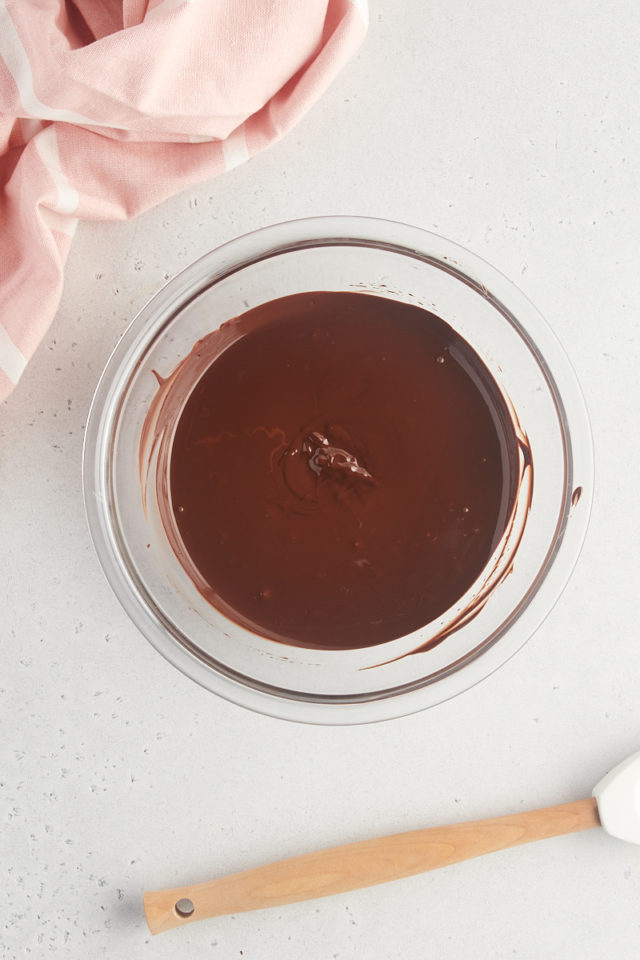 overhead view of melted dark chocolate in a glass bowl