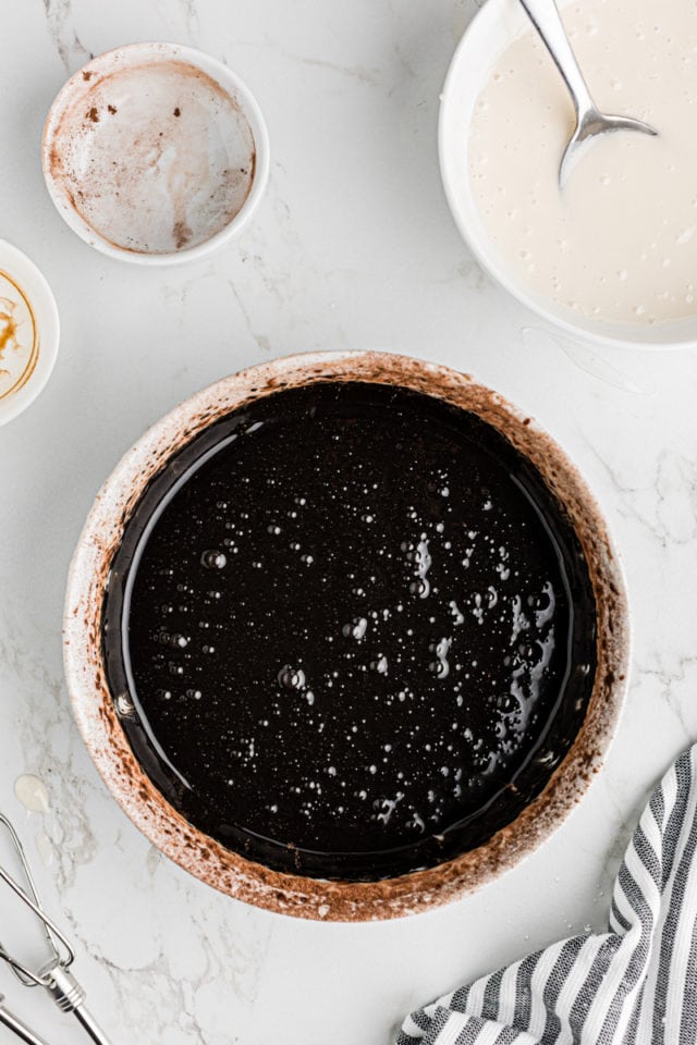 overhead view of chocolate icing in a white bowl