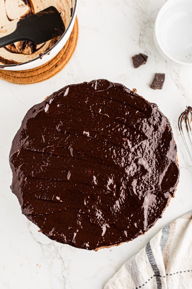 Overhead view of chocolate ganache on hazelnut mousse cake