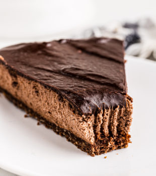 Slice of hazelnut mousse cake on plate with tip eaten