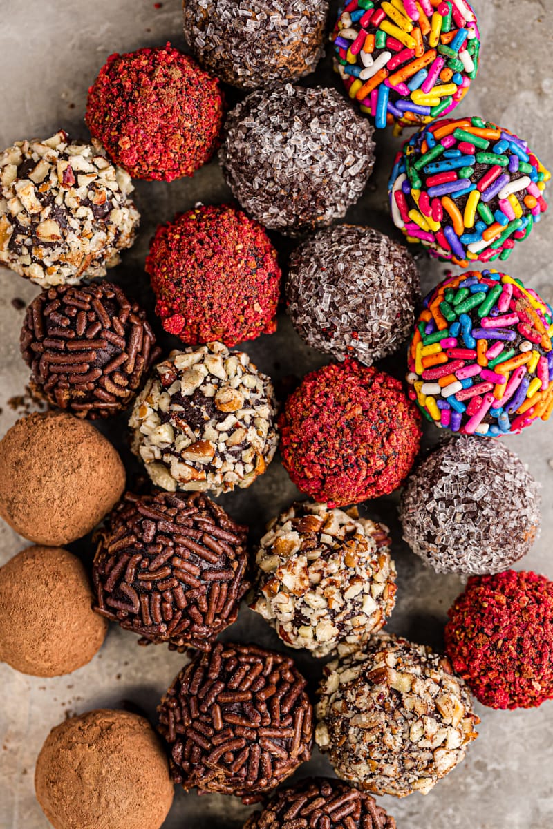 overhead view of chocolate truffles with various coatings on a baking sheet