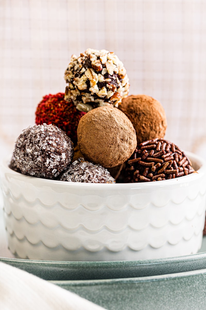 a white bowl filled with chocolate truffles
