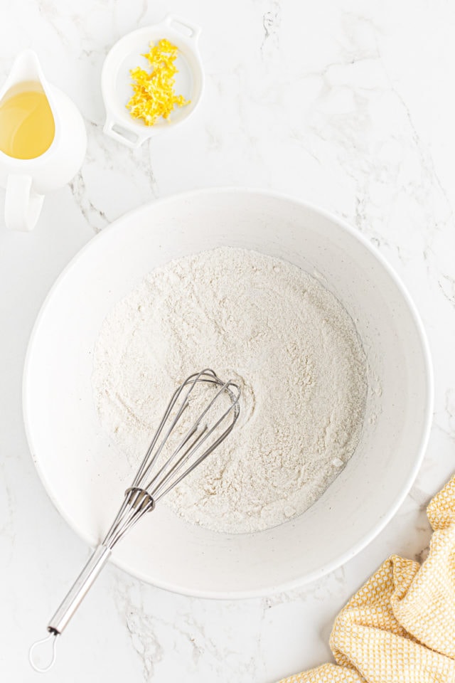 overhead view of flour and sugar whisked together in a mixing bowl