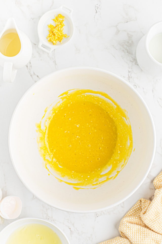 overhead view of combined egg yolks and butter in a mixing bowl