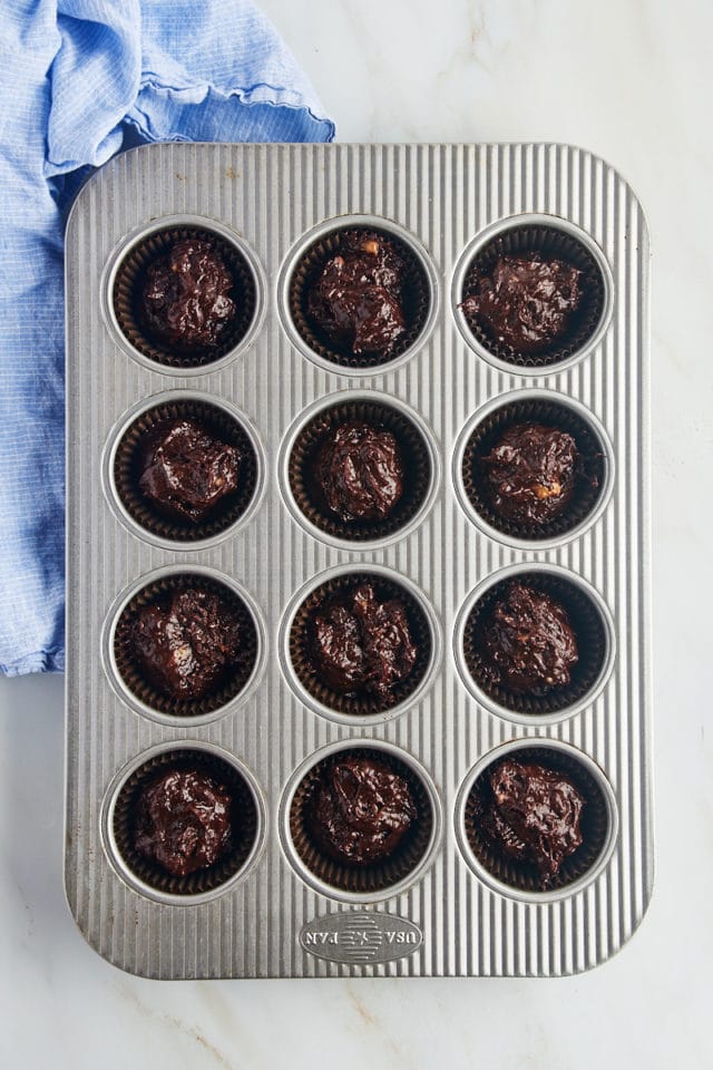 Overhead view of chocolate banana muffin batter in pan