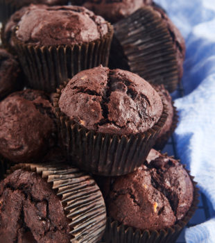 Stack of chocolate banana muffins on wire rack