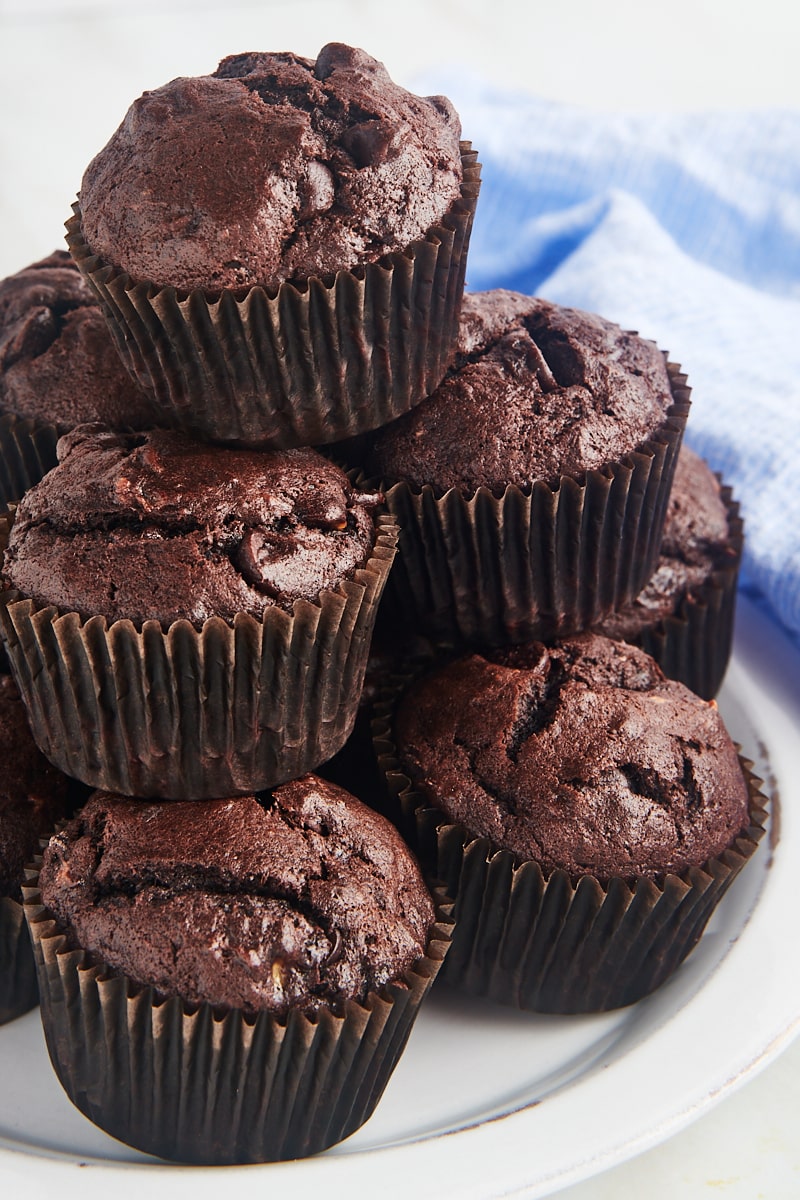 Chocolate banana muffins stacked on plate
