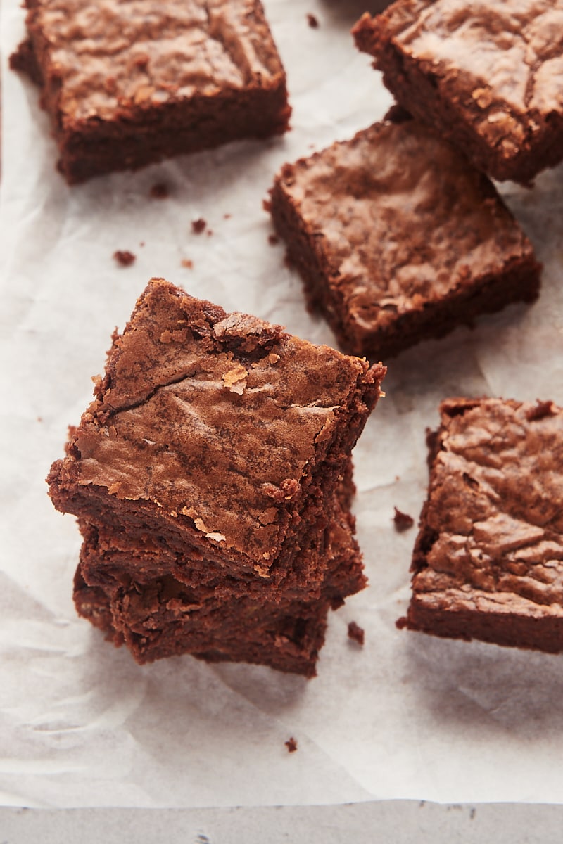 Stacks of fudgy brownies on parchment paper