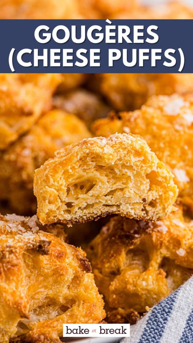half of a gougères sitting on top of more in a white bowl; text overlay "gougères (cheese puffs) bake or break"