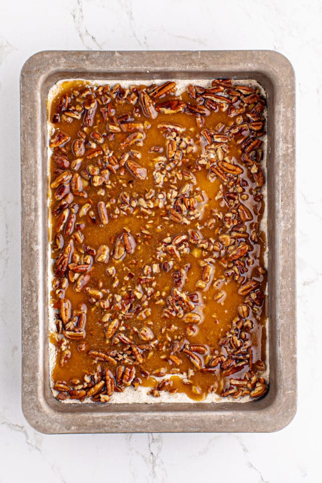 overhead view of the caramel layer added to butter pecan turtle bars