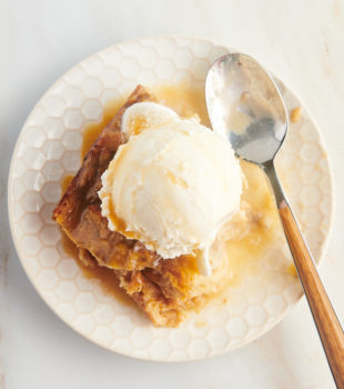 Overhead view of banana bread pudding on plate with vanilla ice cream