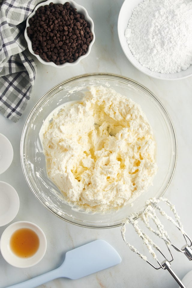 overhead view of mixed ricotta and mascarpone cheeses in a glass mixing bowl
