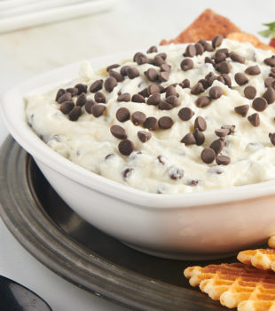 cannoli dip in a white bowl on a pewter tray