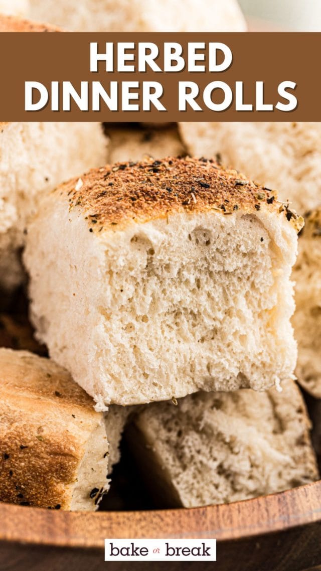close-up of a fluffy dinner roll on top of more rolls; text overlay "herbed dinner rolls bake or break"
