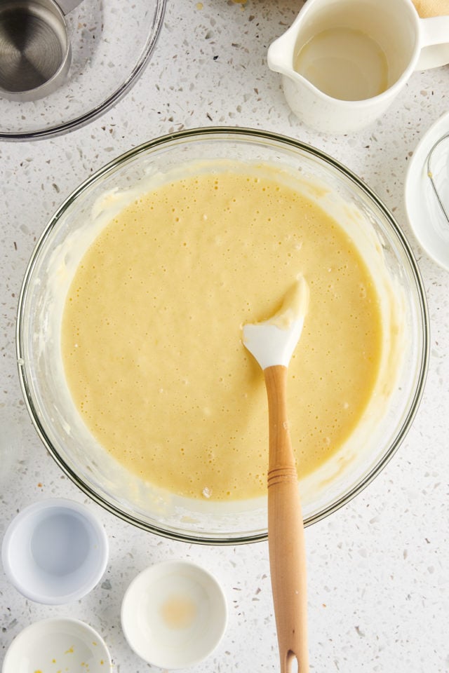 overhead view of olive oil cake batter in a glass mixing bowl