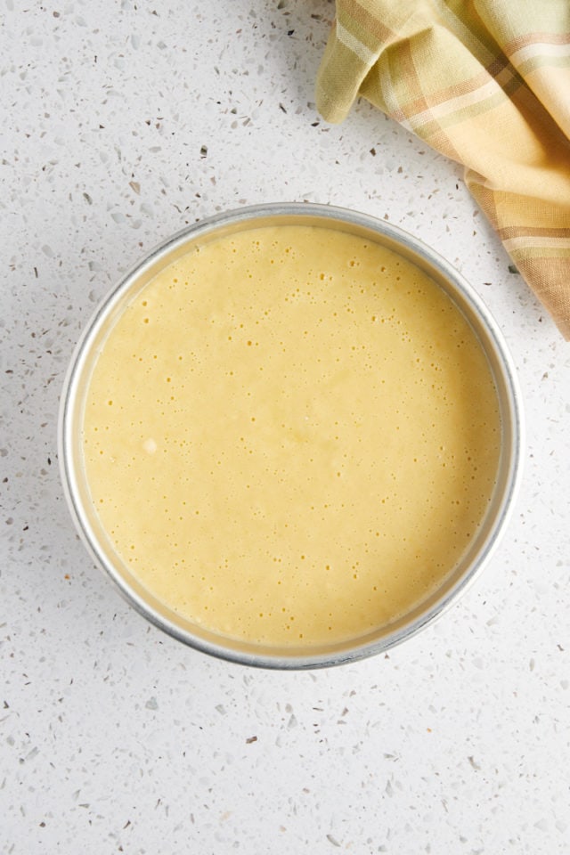 overhead view of olive oil cake batter in a round cake pan