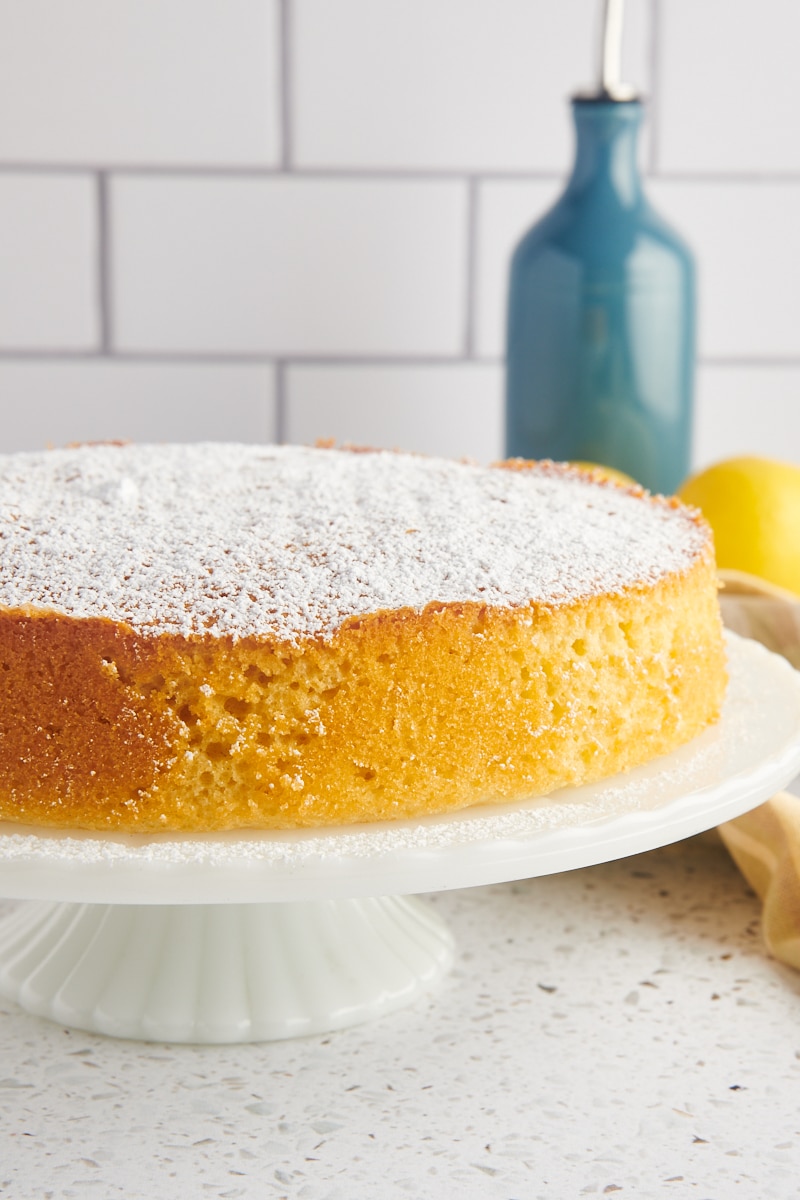 olive oil cake on a white cake stand