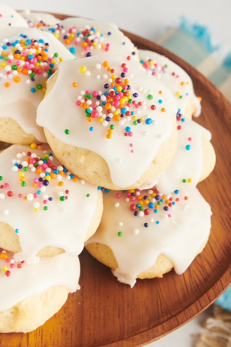 close-up view of sour cream cookies on a small wooden cake stand